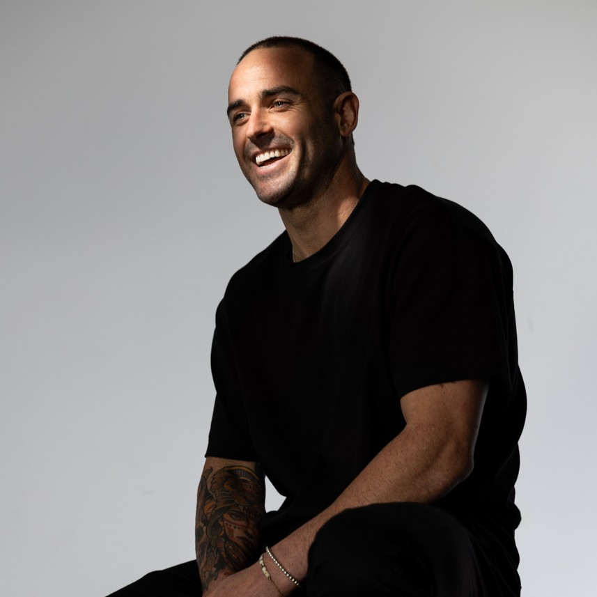 Davey Lloyd smiling in a black t-shirt